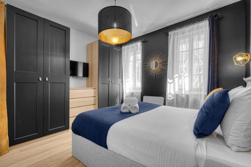 une chambre avec un grand lit avec des oreillers bleus et blancs dans l'établissement L'Azzurri - Charmant appartement pour 4, à Toulouse