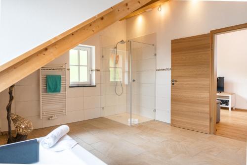 a bathroom with a shower with a glass door at Ferienwohnungen Zober am Mühlbach in Oberammergau