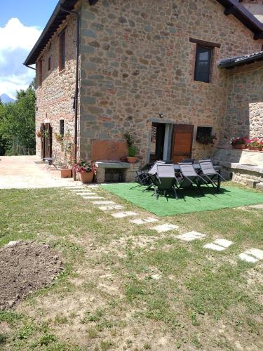 a patio with a table and chairs in front of a building at Villa Belvedere in Pieve Fosciana