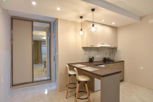 a kitchen with a counter and a island in a room at Apartments Jelušić in Budva