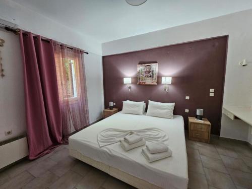 a bedroom with a bed with two towels on it at Corfu Glyfada Menigos Resort 149 in Glyfada