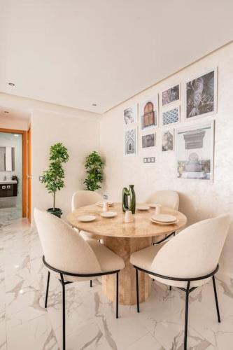 a dining room with a wooden table and chairs at TT Holidays Cosy apartment Rabat City Center in Rabat