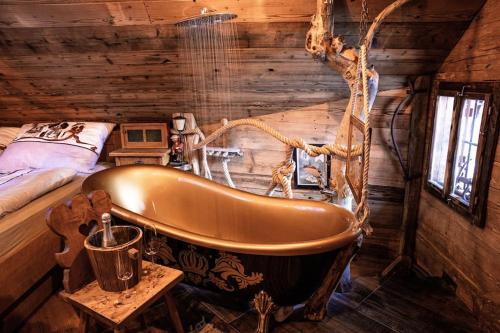 a bathroom with a tub in a log cabin at Troadkasten - Nationalpark Kalkalpen in Ramsau