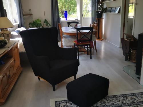 a living room with black chairs and a table at Utleiebolig Fannrem in Fannrem