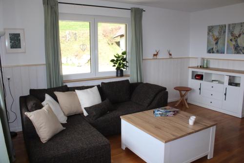 a living room with a couch and a coffee table at Ferienwohnung deine Rauszeit in Seebach