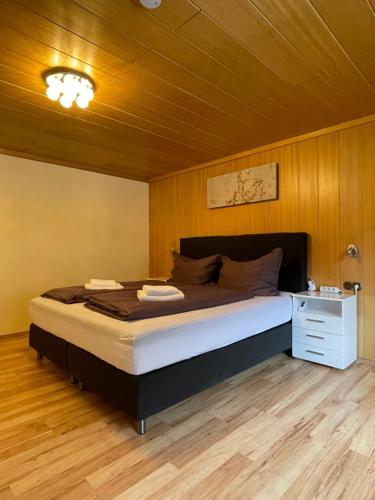 a bedroom with a large bed with a wooden ceiling at Haus St. Martin in Klösterle