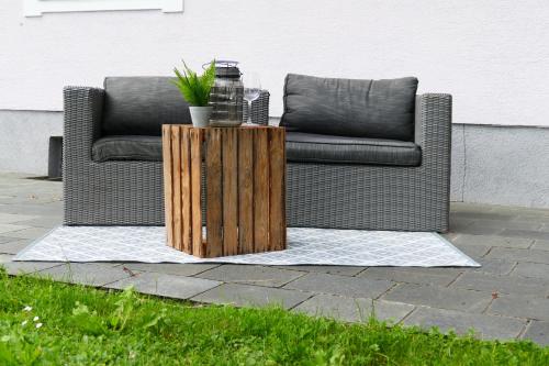 a couch sitting on a patio with a wooden table at Ferienhaus Moser 