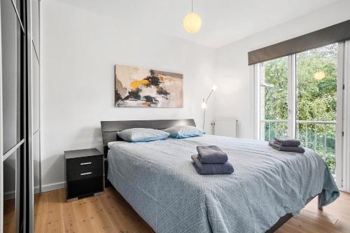 a bedroom with a bed with two towels on it at Cozy 2-Bed Apartment in Aalborg in Aalborg