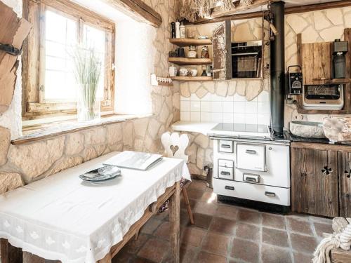 a kitchen with a white table and a stove at Romantik-Suite - Nationalpark Kalkalpen in Ramsau