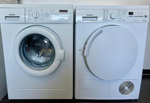 a washing machine and a dryer in a room at pottapartments - balkon - küche - wifi - nespresso in Herne