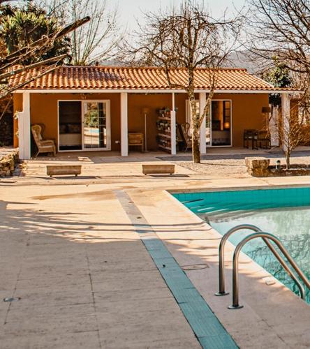 a house with a swimming pool in front of a house at Seixomil - Casa de Campo Boutique Design in Celorico de Basto