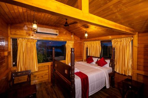 a bedroom with a bed in a wooden cabin at CHETTINAD HERITAGE WELLNESS RESORTS in Mithilaipatti