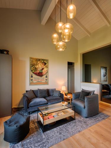 a living room with two blue couches and a coffee table at iCOLLIROSSI Agriturismo in Monforte dʼAlba