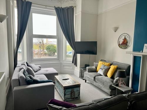 a living room with a couch and a table at Queens Gate in Portsmouth