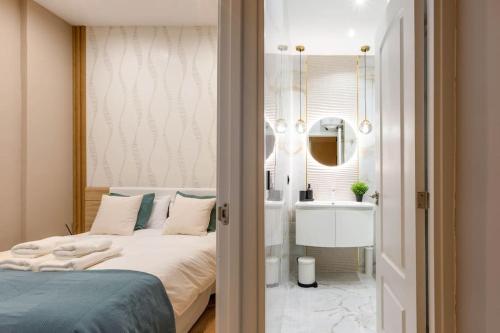 a bedroom with a bed and a bathroom with a sink at Modern and Cozy-1 Bedroom1 Bathroom- Anton Martin in Madrid