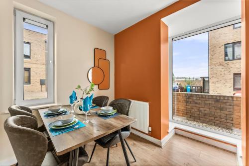 a dining room with a table and chairs and a window at Sleek and Stylish 2 Bed with Garden and Parking in Sheffield