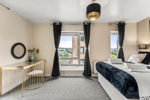 a bedroom with a bed and a window at Sleek and Stylish 2 Bed with Garden and Parking in Sheffield