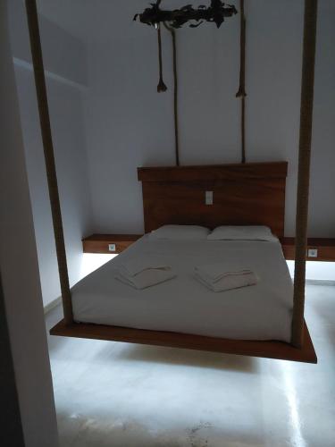 a bedroom with a bed with a wooden frame at Golden Star Praxitelous in Agia Marina Aegina