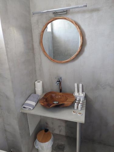 a bathroom with a wooden sink and a mirror at Golden Star Praxitelous in Agia Marina Aegina