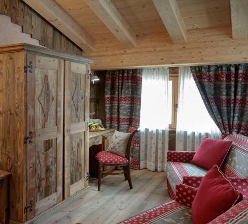 a living room with a couch and a chair at Francois Boutique Rooms - Matterhorn Retreat & SPA in Cervinia in Breuil-Cervinia