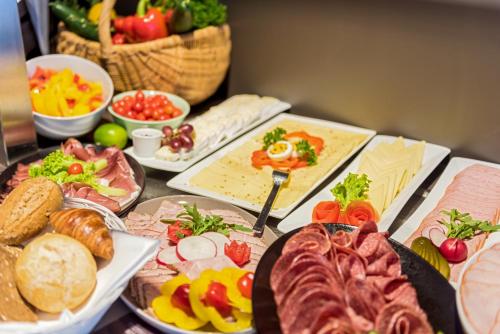 a table with many different types of food on it at ibis Hotel Regensburg City in Regensburg