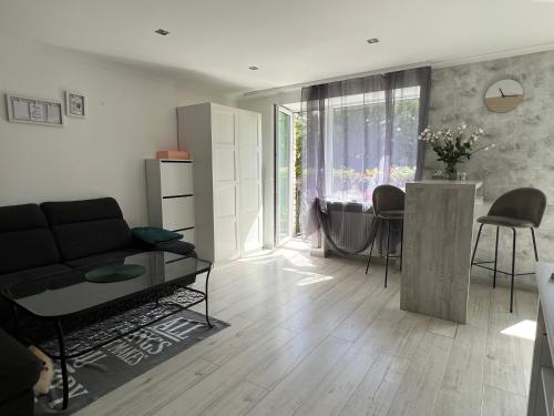 a living room with a couch and a table at Cozy apartment in Jūrmala