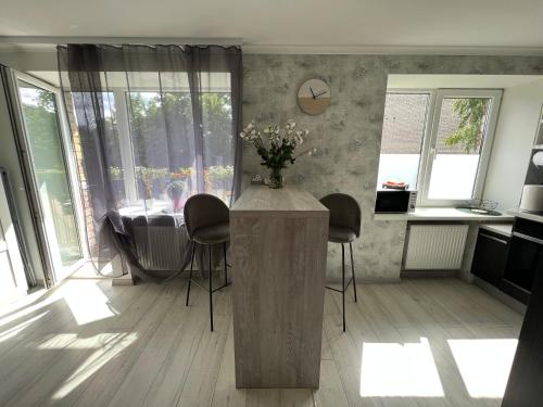 a kitchen with a table and chairs in a room at Cozy apartment in Jūrmala