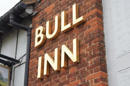 a sign on the side of a brick building at Bull Hotel by Greene King Inns in Halstead