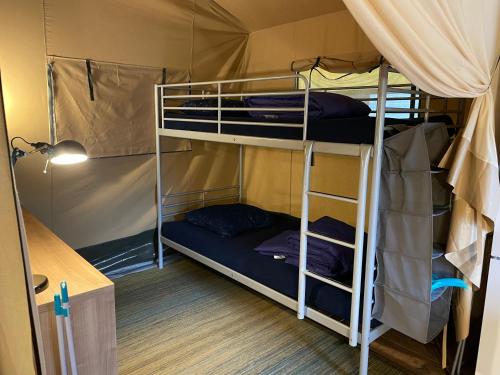 a room with two bunk beds in a tent at Camping Engelbert (Groningen) in Groningen