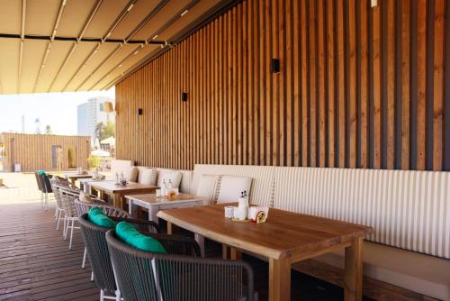 a row of tables and chairs in a restaurant at Admiral Hotel - Ultra All Inclusive & Private Beach in Golden Sands