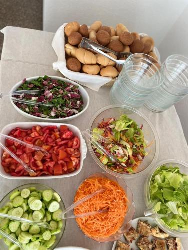 a table topped with bowls of different types of food at Hotel Tre Stelle Gabicce Mare in Gabicce Mare