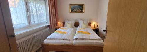 a room with two beds with pillows and a window at Gästehaus Casa Cristina in Bad Krozingen