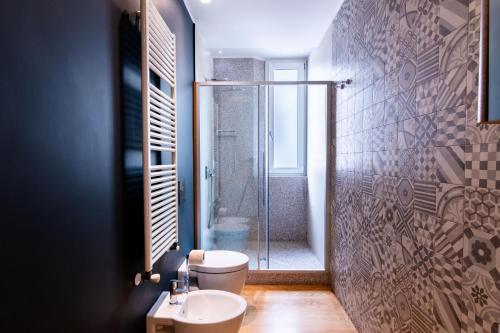 a bathroom with a shower and a toilet and a sink at Oliveri Vintage House at Politeama in Palermo