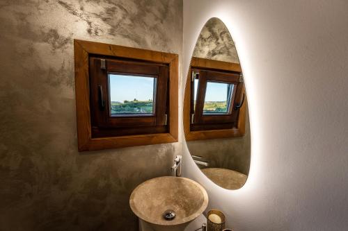 uma casa de banho com um lavatório e dois espelhos na parede em Flori Haus Saschiz em Saschiz