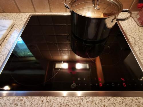 a pot is sitting on top of an oven at Ca da Lovi in Cerentino