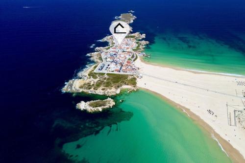 an aerial view of a lighthouse on a beach at Apartamento Isabela - Baleal Island, 50m to the beach in Baleal