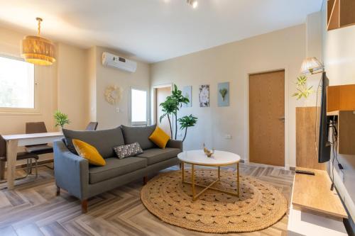 a living room with a couch and a table at BIRD NEST Near Arkan Plaza in Cairo
