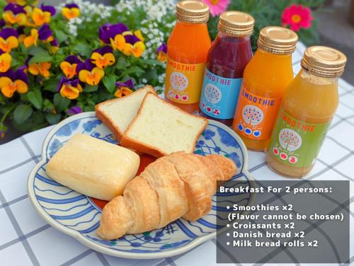 a plate of food with bread and bottles of juice at The Guest Villa 箱根湯本 V-II in Hakone