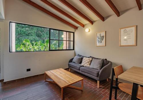 a living room with a couch and a table at The Somos Flats Laureles in Medellín