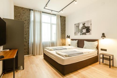 a bedroom with a bed and a desk and a window at Viral 2 BR Photo Studio Loft in Sofia