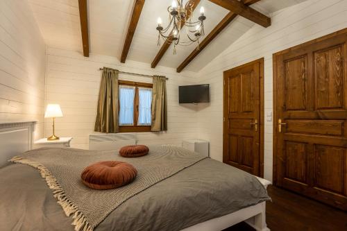 a bedroom with a bed with two pillows on it at Flori Haus Saschiz in Saschiz