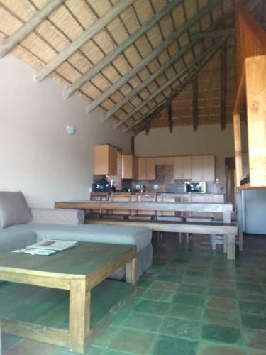 a living room with a couch and a table at Mahikeng Lodge in Magaliesburg
