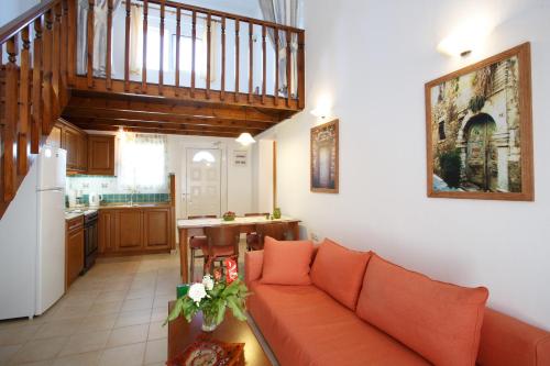 a living room with a couch and a kitchen at Morpheas Apartments in Plakias