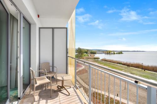 a balcony with a view of the water at Sirius Hotel****Superior in Keszthely