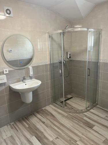 a bathroom with a shower and a sink at Guest House Zatyshnyi Dvir in Bukovel