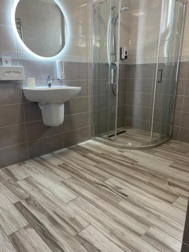 a bathroom with a sink and a shower at Guest House Zatyshnyi Dvir in Bukovel