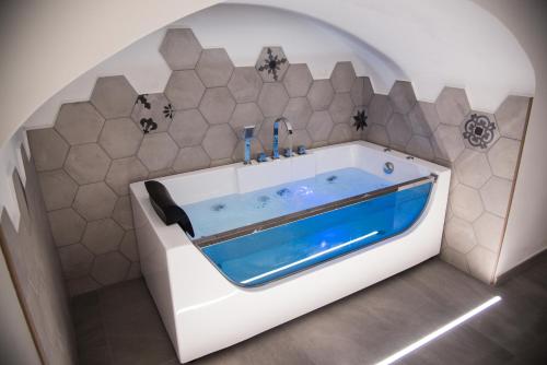 a bathroom with a bath tub in a room at Il Cocchiere in Palagianello
