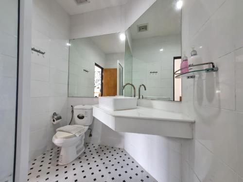 a white bathroom with a sink and a toilet at MAR24 Koh Tao Hotel in Koh Tao