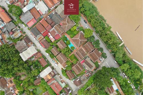 a model of a city with houses and trees at Victoria XiengThong Palace in Luang Prabang