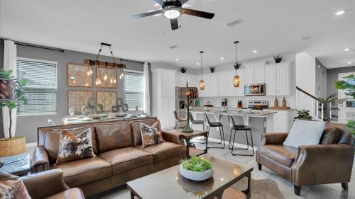 a living room with a couch and a kitchen at 2147 Cooper Bell in Kissimmee